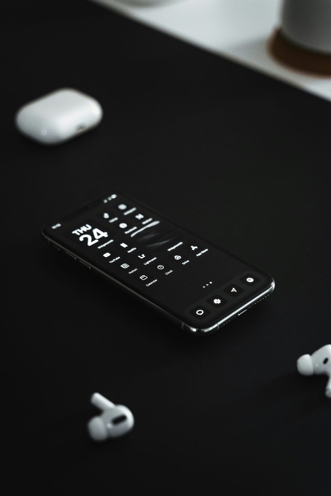 A smartphone on a desk showing a clean, minimal app interface